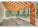 Spacious covered patio with wood columns and beams overlooking the backyard at 4201 Regal Ridge Rd, Austell, GA 30106