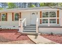 Inviting front porch with updated railings and landscaping, leading to a freshly painted entry door at 4201 Regal Ridge Rd, Austell, GA 30106