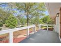 Relaxing front porch with white railing, overlooking the beautifully landscaped front yard at 4201 Regal Ridge Rd, Austell, GA 30106