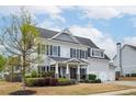 Charming two-story home featuring a welcoming front porch and well-maintained landscaping at 524 Tackett Farms Rd, Smyrna, GA 30082