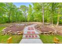 Lush backyard featuring stone pathways and landscaping creating a tranquil outdoor space perfect for relaxation and enjoyment at 2633 Jonesboro Rd, Fairburn, GA 30213