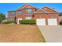 Inviting brick two-story home featuring a two-car garage and well-maintained landscaping at 3971 Busby Mill Ct, Ellenwood, GA 30294