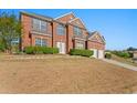 Lovely two-story brick home boasts manicured shrubs and a two-car garage at 3971 Busby Mill Ct, Ellenwood, GA 30294