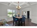 Bright dining space with coffered ceilings, wood floors, and a view to the backyard at 524 Trousseau Ln, Mcdonough, GA 30252