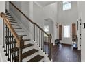 Inviting foyer with a staircase, wood floors, and natural light streaming in from the front door at 524 Trousseau Ln, Mcdonough, GA 30252