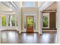 Bright foyer with wood floors, white trim, and a clear view of the landscaped front yard at 550 Vinings Springs Se Dr, Mableton, GA 30126
