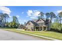 Two-story home featuring a landscaped yard and architectural details, nestled in a tranquil neighborhood setting at 6062 Fielder Way, Douglasville, GA 30135