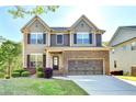 Attractive two-story house with lush landscaping, highlighting a modern architectural design at 2272 Misty Brook Ct, Buford, GA 30519