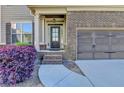 Inviting entryway with decorative plants and an attached garage, emphasizing curb appeal at 2272 Misty Brook Ct, Buford, GA 30519
