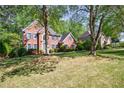Lovely brick home with mature trees and a spacious front yard at 415 Oak Laurel Ct, Johns Creek, GA 30022