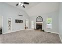 Spacious living room with high ceilings, a fireplace, carpet, and plenty of natural light at 5640 Rolling Oaks Dr, Cumming, GA 30040
