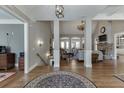 Open-concept living area with gleaming hardwood floors and views of the fireplace, living room, and staircase at 6050 Eagle Close Ln, Sugar Hill, GA 30518