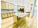 Bright kitchen with stone backsplash, light wood cabinets, granite countertops, and stainless steel appliances at 7675 Lanier View Rdg, Cumming, GA 30041