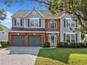 Inviting two-story home features a well-kept lawn, a two-car garage, and a welcoming entrance at 3317 Ridgemill Cir, Dacula, GA 30019