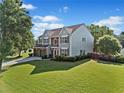 Spacious home with a large front yard, two-car garage, and mature trees under a bright sky at 3317 Ridgemill Cir, Dacula, GA 30019