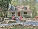 Inviting home featuring a front porch, fire pit area with chairs, and landscaped surroundings at 1004 Westminister Ct, Woodstock, GA 30188
