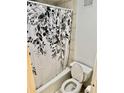 Bathroom featuring a bathtub with floral shower curtain and standard toilet at 2479 Ne Peachtree Ne Rd # 1112, Atlanta, GA 30305