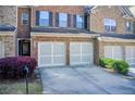 Attractive brick townhome featuring a two-car garage and well-maintained landscaping at 3365 Vintage Se Cir, Smyrna, GA 30080