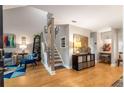 Bright entryway featuring hardwood floors, modern staircase with stylish railings, and tasteful decor leading to the living spaces at 2002 Cedar Chase Ne Ln, Atlanta, GA 30324