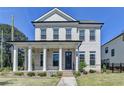 Charming two-story home featuring a welcoming front porch with elegant columns and a well-manicured lawn at 3003 Evanshire Ave, Duluth, GA 30096
