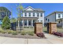 Beautiful home with a black metal fence surrounding a lush, green lawn and manicured landscaping at 3003 Evanshire Ave, Duluth, GA 30096