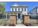 Beautiful home with a black metal fence surrounding a lush, green lawn and manicured landscaping at 3003 Evanshire Ave, Duluth, GA 30096