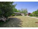 Landscaped front yard and sidewalk leading to a one-story brick home with an attached two-car garage at 4350 Bonaparte Dr, Tucker, GA 30084