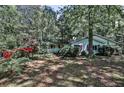 Quaint home nestled amongst mature trees, featuring a red dumpster at 1164 Oldfield Rd, Decatur, GA 30030