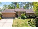 Beautiful single-Gathering home with attached garage, well-maintained lawn, and mature trees at 4030 Muirfield Ln, Marietta, GA 30068