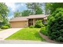 Charming single-Gathering home featuring an attached garage, lush landscaping, and stone accents at 4030 Muirfield Ln, Marietta, GA 30068