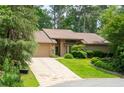 Charming single-Gathering home featuring an attached garage, lush landscaping, and stone accents at 4030 Muirfield Ln, Marietta, GA 30068