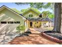 Charming home featuring a brick walkway, mature trees, a front porch with seating, and an attached garage at 4157 Town Branch Ct Sw, Covington, GA 30014