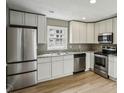 Modern kitchen with stainless steel appliances, granite countertops, and white cabinets at 1545 Orlando Sw St, Atlanta, GA 30311
