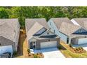 Aerial view of a brick home with attached garage, nestled among other homes and lush trees at 2617 Cacao Sq, Acworth, GA 30101