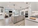 Spacious kitchen with granite counters, stainless appliances, and an open view of living area at 3220 Montebello Pkwy, Cumming, GA 30028