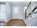 Inviting foyer with hardwood floors, staircase and a front door with decorative glass at 1697 Ramblewood Way, Snellville, GA 30078