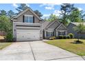 A gray two-story home with a well-manicured lawn and an inviting driveway at 2075 Villa Spring Ct, Dacula, GA 30019