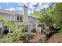 Private backyard with patio, perfect for outdoor dining and relaxation with mature landscaping and fencing at 3065 Camden Way, Alpharetta, GA 30005