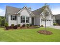 Inviting home with manicured lawn, landscaped garden bed, and an attached two car garage at 408 Cottonwood Cir, Peachtree City, GA 30269
