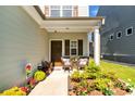 Charming front porch with seating area and beautifully landscaped garden at 637 Sunflower Dr, Canton, GA 30114