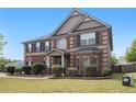 Attractive two-story brick home features manicured landscaping, a welcoming entrance, and traditional architectural details at 640 Parkside Place Dr, Mcdonough, GA 30253