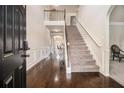 Elegant foyer features hardwood floors, a staircase with iron spindles, and wainscoting adding a touch of sophistication at 640 Parkside Place Dr, Mcdonough, GA 30253