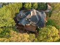 Aerial view of the home with a large deck and lush surroundings, for privacy and outdoor living at 519 River Estates Pkwy, Canton, GA 30115
