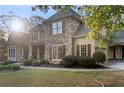 Well-maintained home featuring stone accents, red shutters, and a beautifully manicured lawn at 519 River Estates Pkwy, Canton, GA 30115