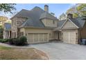 Spacious three-car garage with stone accents and well-kept landscaping at 519 River Estates Pkwy, Canton, GA 30115