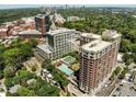Expansive aerial view showing a swimming pool nestled among several buildings and lush greenery at 1820 Peachtree Nw St # 1008, Atlanta, GA 30309
