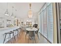 Stylish eat-in kitchen with stainless appliances, bar seating, and an adjacent dining area and living room at 1820 Peachtree Nw St # 1008, Atlanta, GA 30309