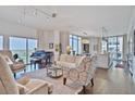 Open concept living room with hardwood floors, lots of natural light, and piano at 1820 Peachtree Nw St # 1008, Atlanta, GA 30309
