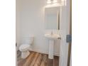 Clean powder room featuring a pedestal sink, modern fixtures, and neutral decor at 2117 Boxwood Se Cir, Conyers, GA 30094