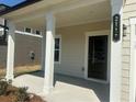 Inviting front porch with classic columns and a modern house number sign at 2117 Boxwood Se Cir, Conyers, GA 30094